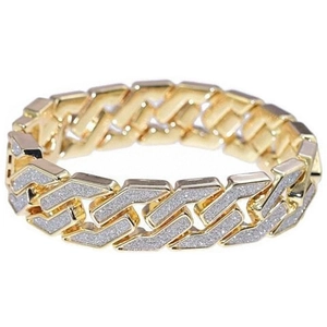 Close-up of men's luxury gold-tone Cuban link bracelet with sparkling textured surface