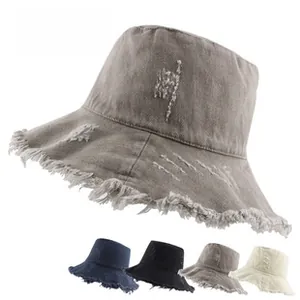 Detailed view of frayed edges and distressed cotton fabric on vintage bucket hats