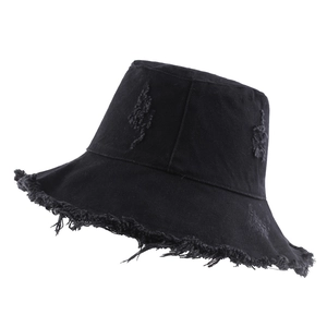 Black frayed cotton bucket hat with distressed denim texture and wide brim for sun protection