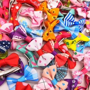 Colorful pet bow hair clips set with floral and polka dot patterns for cats and dogs