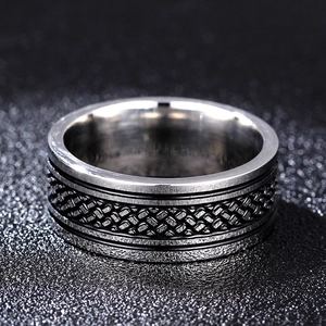 Macro shot of 8mm stainless steel ring showing vintage fish pattern and black enamel details