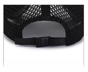 Detailed view of adjustable plastic buckle and breathable mesh on black baseball cap