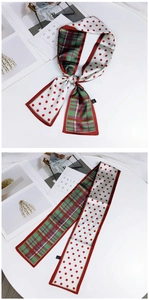Detail of double-sided silk scarf featuring red polka dots and colorful plaid patterns