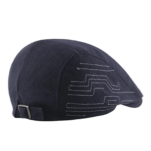 Navy newsboy cap in cotton linen featuring white embroidery and metal adjustment buckle