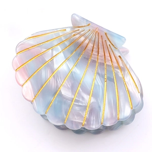 Scallop shell hair claw clip with pearlescent gradient finish and gold etched lines