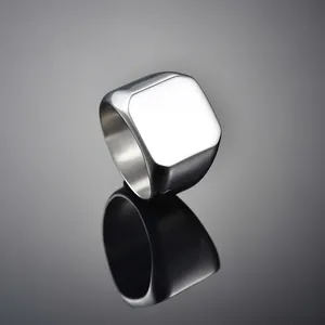 Polished silver stainless steel square signet ring for men on reflective background