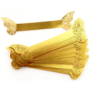 Laser-cut butterfly napkin rings in reflective gold cardstock for wedding table decor