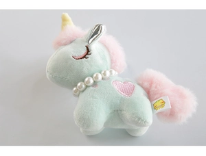Close-up of mint green unicorn plush with pink mane, pearl necklace and gold horn details