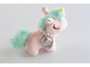 Detail of plush unicorn keychain with pearl necklace and mint green mane in soft pink
