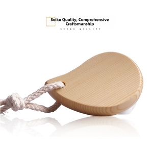 Detailed view of ergonomic wooden massage tool with smooth finish and natural wood grain