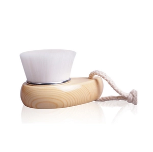 Detail of wooden facial cleansing brush with soft white bristles and hemp hanging loop