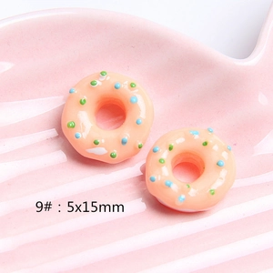 Macro detail of 5x15mm resin donut charm with colorful sprinkles for DIY crafts
