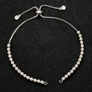 Detail of silver-colored adjustable box chain bracelet with sliding clasp and ring connectors