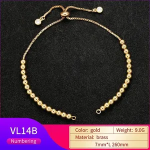 Detail of adjustable brass slider clasp and zircon charms on the gold bead bracelet