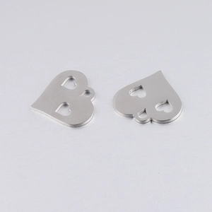 Detailed view of hollow double heart pendant in mirrored stainless steel for DIY jewelry