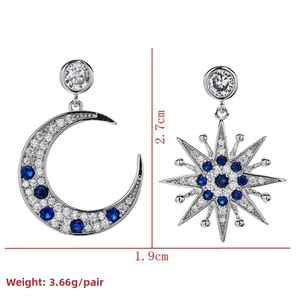 Detail view of asymmetric moon and star earrings showing dimensions 2.7cm by 1.9cm