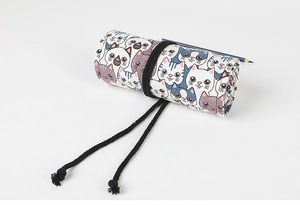 Detail of roll-up pencil wrap with cute cartoon cat pattern and black woven drawstring