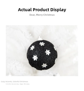 Detail of 8cm black Christmas ball featuring silver floral patterns and glitter texture