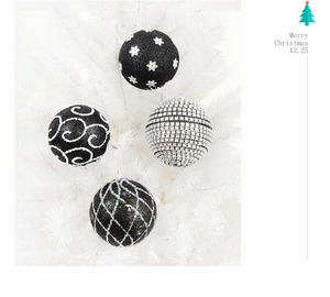 Detailed view of high-quality black and white Christmas baubles with glitter texture