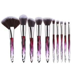 Detailed close-up of 10 professional crystal handle makeup brushes with soft fiber bristles