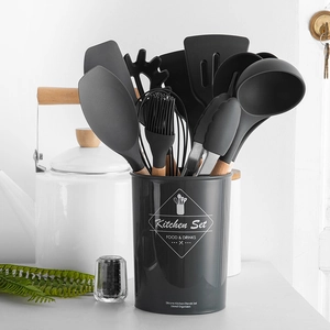 11-piece black silicone kitchen utensil set with wooden handles in a gray storage bucket