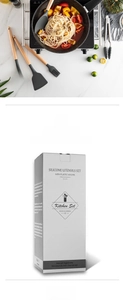Detail of grey silicone kitchen utensil set with wooden handles and branded packaging