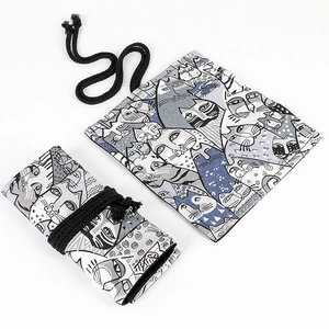 Detail of canvas pencil wrap and drawstring pouch with artistic cat patterns and textures