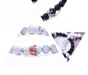 Detailed macro view of black matte agate and white turquoise beads with crown charms