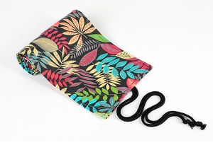Detail of rolled canvas pencil wrap with leaf pattern and black woven binding cord