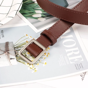 Minimalist brown leather belt for women with elegant square silver buckle on aesthetic background