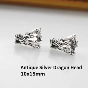 Macro detail of antique silver dragon head metal beads for DIY jewelry making 10x15mm