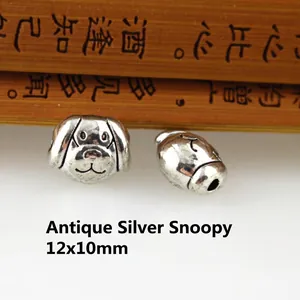 Macro detail of silver Snoopy alloy bead charm with vintage texture and 12x10mm dimensions
