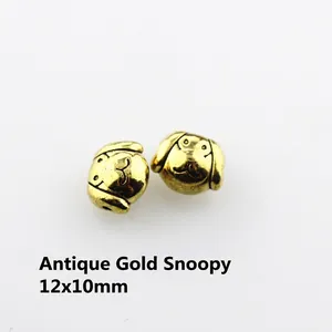Macro detail of antique gold Snoopy head metal charm 12x10mm for DIY jewelry making