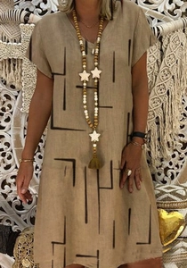 Detail of V-neck khaki cotton linen dress with black geometric line prints and ethnic style