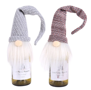 Detail of Christmas gnome wine bottle covers in grey knit with long white fiber beards
