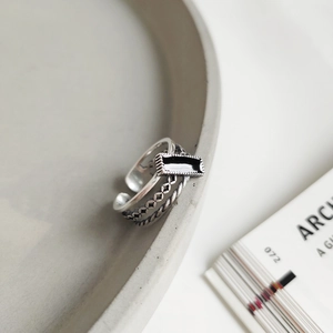 Macro detail of 925 sterling silver ring with black enamel rectangle and layered texture