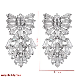 Detail showing geometric baguette zircon earrings measuring 2.3cm by 1.3cm and 3.8g weight