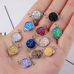 Handheld view of colorful 10mm stainless steel druzy connector charms for DIY jewelry making