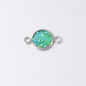 Detail view of 10mm stainless steel drusy connector with green glitter stone for DIY jewelry