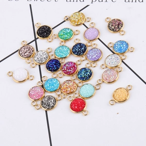 Macro detail of 10mm gold-plated stainless steel charms with colorful resin stones