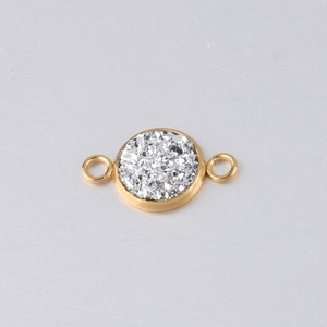 Detailed macro view of a 10mm gold stainless steel round charm with silver glitter inlay