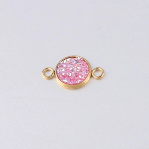 Detailed close-up of 10mm gold stainless steel charm with pink glitter resin inlay