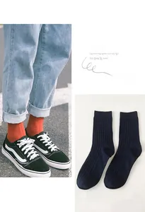 Detailed shot of striped cotton socks in orange and navy with breathable ribbed texture