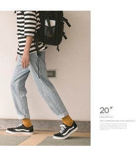 Men's yellow cotton socks styled with denim jeans and black sneakers for casual wear