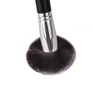 Detail of soft synthetic bristles and silver ferrule of a professional makeup brush
