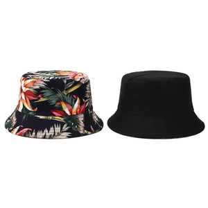 Double-sided reversible bucket hat with tropical floral print and classic solid black color