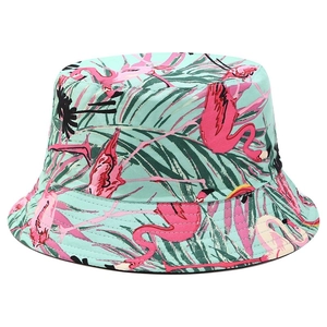 Detail of tropical bucket hat with pink flamingo and palm leaf print on mint green canvas