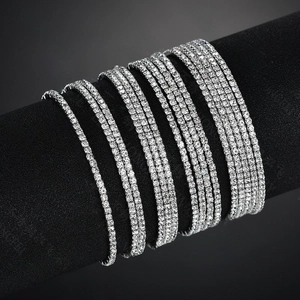 Macro detail of silver tennis bracelets with white rhinestones in various widths
