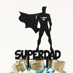Detail of black acrylic Super Dad cake topper featuring hero silhouette and cutout text