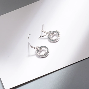 Elegant silver interlocking double hoop earrings with cubic zirconia on a white card